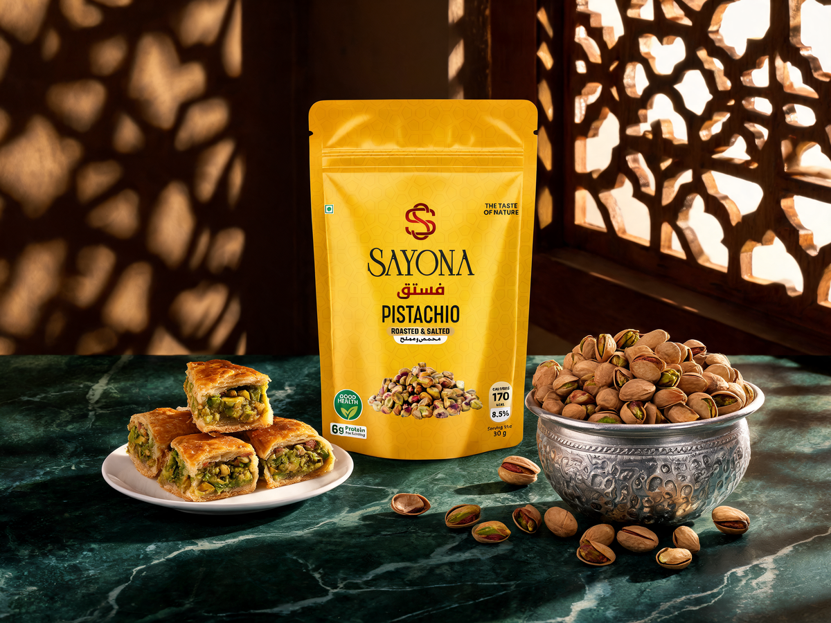 Sayona Pistachio pouch with a silver bowl of pistachios and baklava in mashrabiya window light